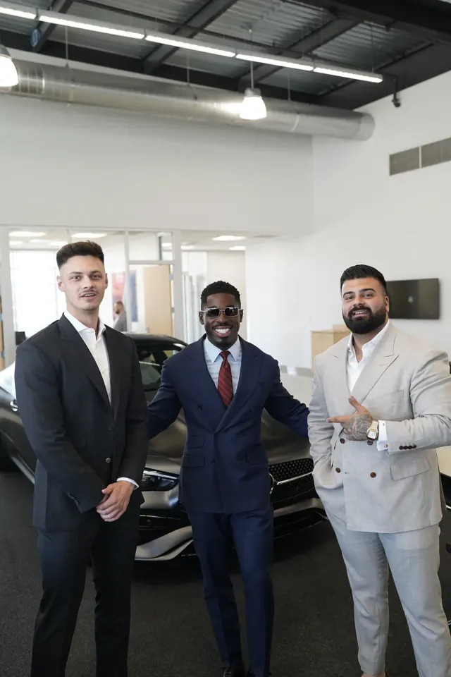 Three Summit Customs clients in custom suits: navy, charcoal and light grey