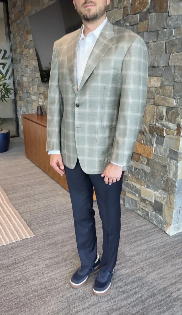 Client wearing a green plaid custom sport coat with dark navy trousers